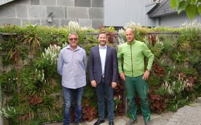 Begrnte Gabionen fr Umwelt-, Schall- und Sichtschutz
Brgermeister besucht Gartenbauunternehmen Hankemeier

Eine praktische Art, im heimischen Garten einen Sicht- und Schallschutz zu installieren, der zugleich Bienen, Hummeln, Schmetterlingen und Co zugutekommt, stellen Pflanzen-Gabionen dar. Davon berzeugte sich der Brgermeister von Herzebrock-Clarholz, Marco Diethelm, krzlich beim Gartenbauunternehmen Hankemeier in Clarholz.

Dabei handelt es sich um eine Art Mauer, bestehend aus einem 180 cm hohen, 250 cm langen und rund 30 cm dicken Metallrahmen, der auen mit Flie und innen mit Substrat gefllt ist. Dort knnen dann individuell an Vorder- und Rckseite Lcher zum Bepflanzen hineingebohrt werden. Die Auswahl an Pflanzen ist gro und flexibel einsetzbar. Je nach Ausrichtung zur Schatten- oder Sonnenseite knnen andere Gewchse ausgewhlt werden. Alle sechs bis acht Wochen kann von auen ein Blattdnger zugefgt werden und recht schnell entsteht eine dichte, lebendige grne Wand.

Mich beeindruckt, dass man damit mehrere Fliegen mit einer Klappe schlagen kann, uert sich Diethelm. Man hat einen Sichtschutz, der zudem auch Gerusche dmpft, was zum Beispiel zwischen Reihenhausterrassen von Vorteil ist. Es ist eine Freude, die grne Wand mit ihren Blten und Insekten anzusehen. Umweltschutz kann damit richtig Spa machen, so der Brgermeister. 

Die Klimaschutzmanagerin der Gemeinde, Caroline Httemann, ergnzt Nicht nur fr Insekten sind die Pflanzen-Gabionen ein Paradies, der Bewuchs beeinflusst auch das Mikroklima vor Ort positiv: Durch die Verdunstung der Pflanzen entsteht ein khlender Effekt der insbesondere im Sommer fr die Menschen sehr angenehm ist. Mauern aus Stein wrden dagegen Hitze speichern und an die Umgebung abstrahlen. Ein Faktor, der in Zeiten des Klimawandels zunehmend an Bedeutung gewinnt. 

Viel Freude hatte Diethelm auch bei der Energie-Technik, die die Hankemeiers fr Geschfts- und Wohnhaus bereits erfolgreich nutzen. Dazu zhlen eine Photovoltaikanlage, ein Kaminofen, der zugleich Wasser erhitzt, das gespeichert und zum Heizen eingesetzt werden kann sowie die E-Mobilitt der dienstlichen und privaten Fahrzeuge. Ein Batteriespeicher sowie ein Wasserstoffspeicher fr die PV-Anlage sollen mglichst bald nachgerstet werden.

Rudolf und Christopher Hankemeier geben ihre Erfahrungen gern weiter: Wir zeigen unsere Technik-Lsung gern auch anderen interessierten Unternehmen, bieten die beiden an.

Ein schnes Beispiel, dass es in Herzebrock-Clarholz kreative Lsungen gibt, Klimaschutz und Energieerzeugung sinnvoll zu kombinieren. Ich wei auch von anderen Privatleuten und Unternehmen, die sich da schon auf den Weg gemacht haben. Die Gemeindeverwaltung untersttzt dies gern mit Beratung und weiterfhrenden Informationen so Diethelm.
